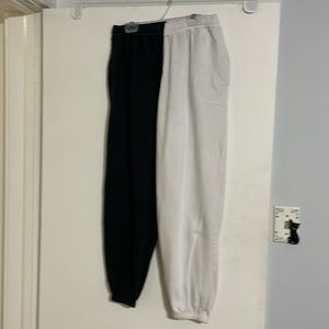 Desert Dreamer 1 black leg and 1 white leg track pants in size Medium.
